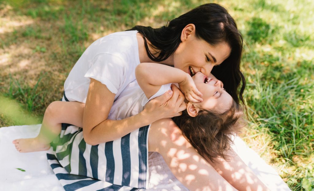 happy mom with toddler, knows about must-have items for toddler moms